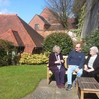 Residents enjoying the gardens with one of the trustees